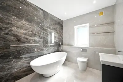 a bathroom with a large white tub and a sink at Fell View & Beaufort House in Preston
