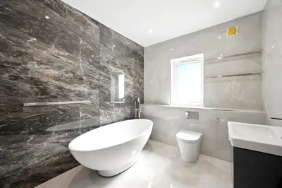 a bathroom with a large white tub and a sink at Fell View & Beaufort House in Preston