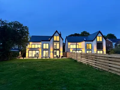 a large house with a fence in front of it at Fell View & Beaufort House in Preston