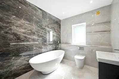 a bathroom with a large white tub and a sink at Fell View & Beaufort House in Preston