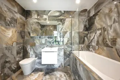 a bathroom with a toilet and a tub and a sink at Fell View & Beaufort House in Preston