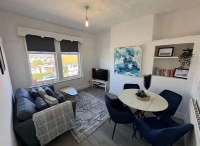 a living room with a couch and a table at Beach Apartments in Cleveleys