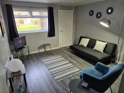 a living room with a couch and a tv at Self-contained 1 bedroom flat in Liverpool