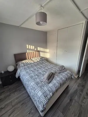 a bedroom with a bed with a blanket on it at Self-contained 1 bedroom flat in Liverpool
