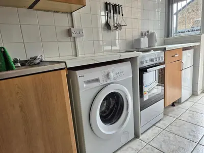 a kitchen with a washing machine and a sink at Self-contained 1 bedroom flat in Liverpool