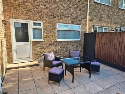 a patio with a table and chairs and a building at Self-contained 1 bedroom flat in Liverpool