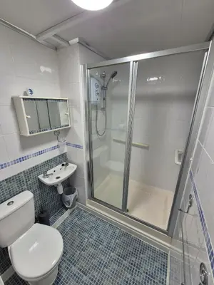 a bathroom with a shower and a toilet and a sink at Self-contained 1 bedroom flat in Liverpool