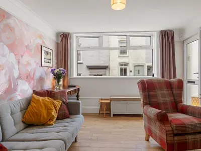 a living room with a couch and two chairs at Pass the Keys Bright Town-Centre Flat with Outdoor Area in Ulverston