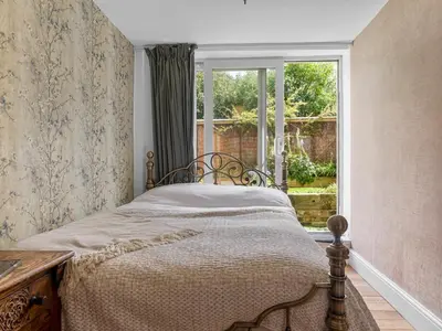 a bedroom with a bed and a window at Pass the Keys Bright Town-Centre Flat with Outdoor Area in Ulverston