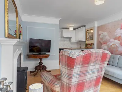 a living room with a couch and a chair at Pass the Keys Bright Town-Centre Flat with Outdoor Area in Ulverston