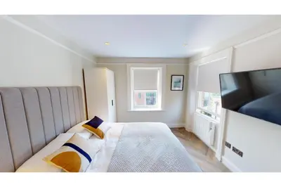 a bedroom with a bed and a flat screen tv at 2 Mins to Cathedral Georgian Quarter CityBreak in Liverpool