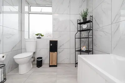 a white bathroom with a toilet and a tub at 4 Bed near Anfield Stadium-Perfect for Groups & Contractors in Liverpool
