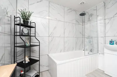 a white bathroom with a tub and a sink at 4 Bed near Anfield Stadium-Perfect for Groups & Contractors in Liverpool