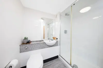 a white bathroom with a sink and a shower at Student Only Ensuite at Prospect Point Liverpool in Liverpool