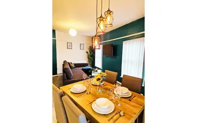 a dining room with a table and a couch at Lodginet Stays - County Heights - 2BR Flat 3 in Liverpool