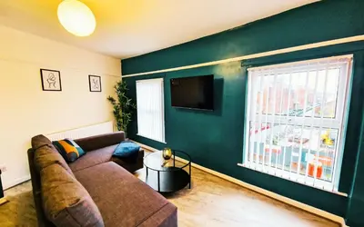 a living room with a couch and a television at Lodginet Stays - County Heights - 2BR Flat 3 in Liverpool