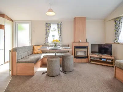 a living room with a couch and a television at Coastal Comfort in Millom