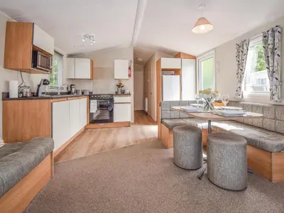 a kitchen and living room with a couch and a table at Coastal Comfort in Millom