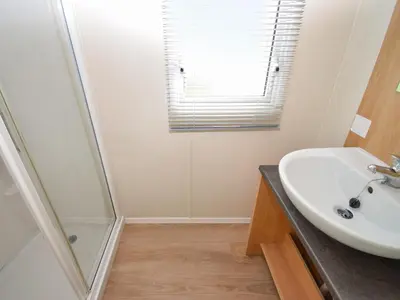 a bathroom with a sink and a shower at Coastal Comfort in Millom
