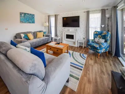 a living room with two couches and a fireplace at Sunnybank in Warton