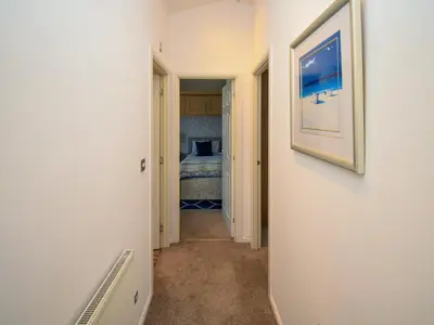 a hallway leading to a bedroom with a bed at Sunnybank in Warton