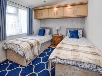 a bedroom with two beds and a window at Sunnybank in Warton