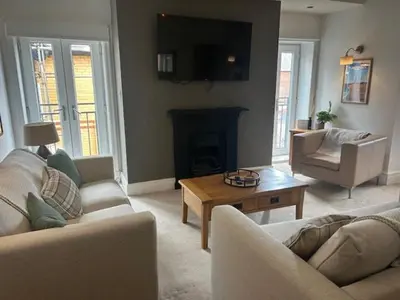 a living room with two couches and a fireplace at St Annes Spacious Apartment in Saint Annes on the Sea