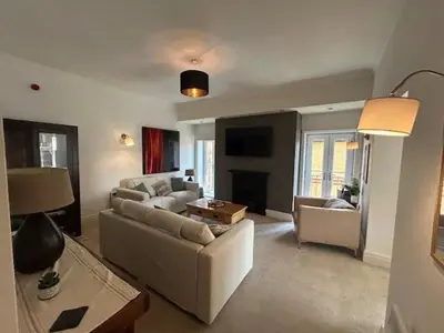a living room with a couch and a table at St Annes Spacious Apartment in Saint Annes on the Sea