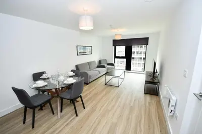 a living room with a table and a couch at Bright Spacious 2 Bedroom Apartment in Liverpool in Liverpool