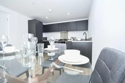 a dining room with a glass table and chairs at Bright Spacious 2 Bedroom Apartment in Liverpool in Liverpool