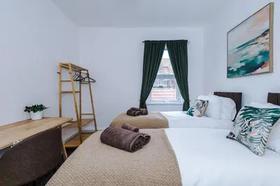 two beds in a room with a window at 2 Bed Apartment ,Sea Views in Blackpool