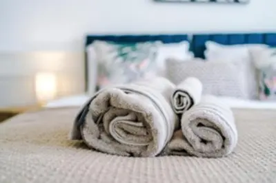 a pile of towels on top of a bed at 2 Bed apartment, sleeps up to 5 in Blackpool