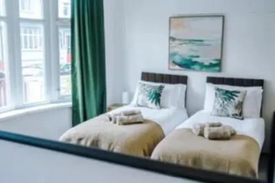 a reflection of a bathroom with a tub and a mirror at 2 Bed apartment, sleeps up to 5 in Blackpool