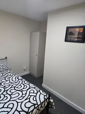 a bedroom with a bed and a picture on the wall at 2wayz Home in Liverpool