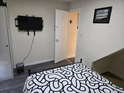 a bedroom with a bed and a flat screen tv at 2wayz Home in Liverpool