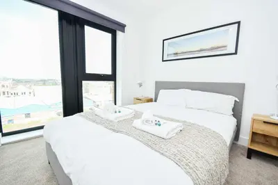 a bedroom with a bed with two towels on it at Modern & Convenient 2 Bedroom Liverpool Apartment in Liverpool