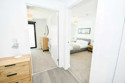 a bedroom with a bed and a mirror at Modern & Convenient 2 Bedroom Liverpool Apartment in Liverpool