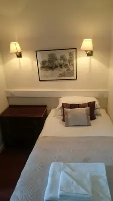 a bedroom with a large bed with two lamps at The Silverdale Hotel in Silverdale