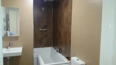 a bathroom with a sink and a bath tub at The Silverdale Hotel in Silverdale