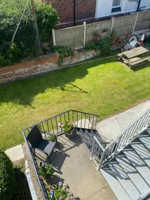 an overhead view of a yard with a bench and flowers at Superior, spacious apartment in New Brighton, near Liverpool in New Brighton