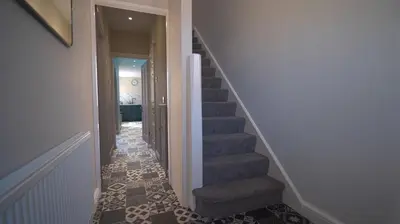 a hallway with a stairway with a stair case at Spacious 3-Bed Home - Central Blackpool in Blackpool