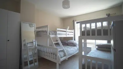 a room with three bunk beds and a mirror at Spacious 3-Bed Home - Central Blackpool in Blackpool