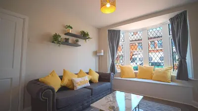 a living room with a couch and a window at Spacious 3-Bed Home - Central Blackpool in Blackpool