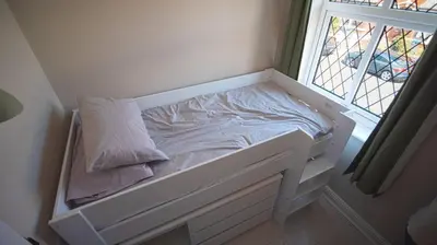 a small bed in a room with a window at Spacious 3-Bed Home - Central Blackpool in Blackpool