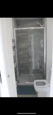 a bathroom with a shower and a white toilet at Lane Stay in Liverpool