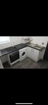 a kitchen with a sink and a stove at Lane Stay in Liverpool