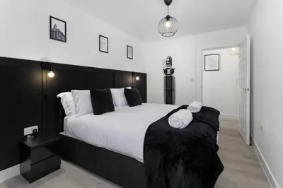 a bedroom with a large bed with two towels on it at #47 Cozy Anfield Near Stadium Free On-Site Parking in Liverpool