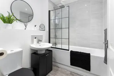 a white bathroom with a sink and a shower at #47 Cozy Anfield Near Stadium Free On-Site Parking in Liverpool