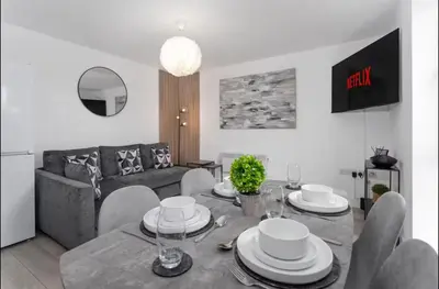 a living room with a table and a couch at #47 Cozy Anfield Near Stadium Free On-Site Parking in Liverpool