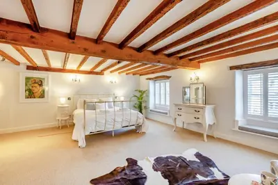 a bedroom with a bed and a wooden ceiling at 4 Bed in Cartmel oc-d31802 in Cartmel